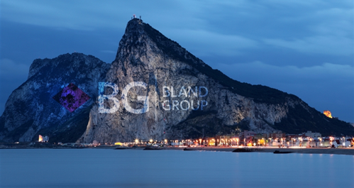 bland group logo projected on side of mountain